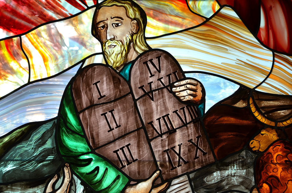 Stained glass depiction of Moses holding the Ten Commandments