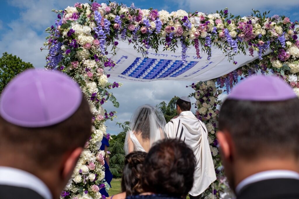 Jewish wedding ceremony underneath a huppa. © Shutterstock.com