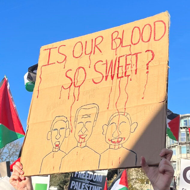 Placard at an anti-Israel protest depicting caricatures of bloodsucking vampires with the words "Is our blood so sweet?"