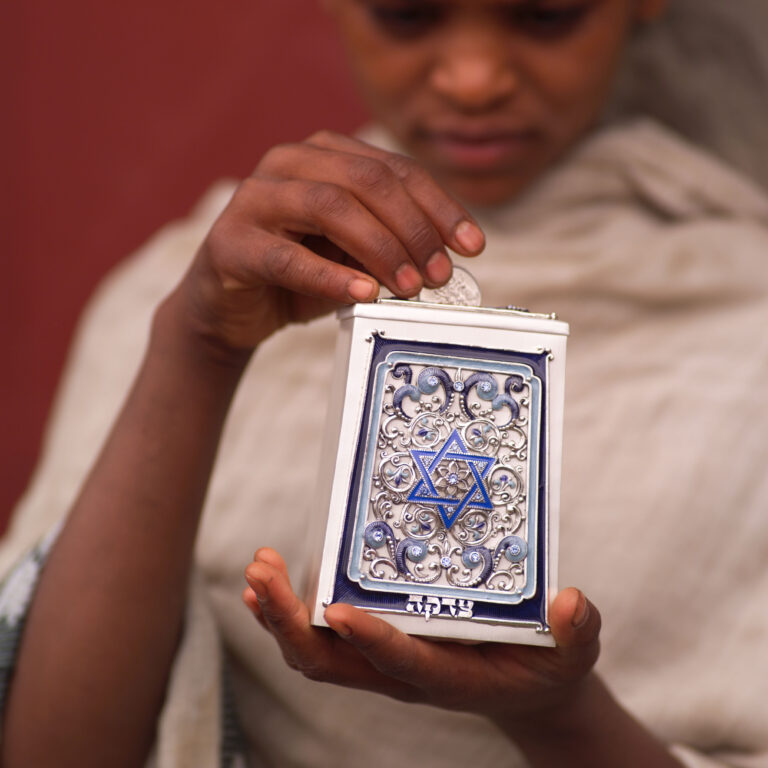 Ethiopian Jewish boy holding a tzedakah box. © Keith Levit / Alamy Stock Photo.
